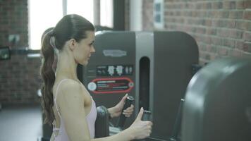 Man and woman doing fitness exercises in gym. Strength, endurance and training focus in modern fitness center 30 video