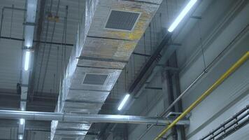 HVAC Duct Cleaning, Ventilation pipes in silver insulation material hanging from the ceiling inside new building. 2 video