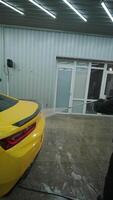 High-Pressure Rinse on Yellow Car with Soap and Suds video