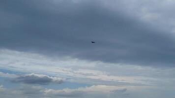 A propeller-driven plane flies through a gloomy cloudy sky video