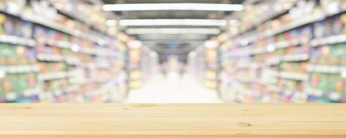 Empty wooden table in supermarket with blurred background photo