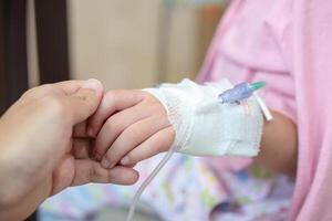A person holding a hand with an iv in it photo