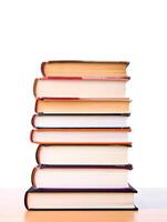 Stack of Colorful Hardcover Books Isolated on White Background photo