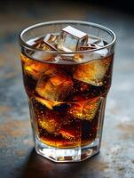 Refreshing Glass of Cola with Ice Cubes and Bubbles on Rustic Background photo