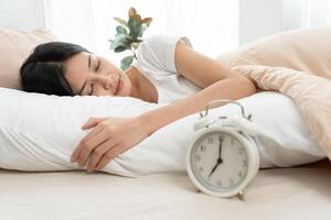 Simple lifestyle. Asian woman sleep well from good sleep on weekend morning, takes some rest, enjoy relax in comfortable bedroom at home window, happy lazy day, enjoy work life balance photo