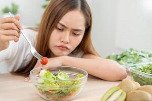 asian women bored diet food, dieting female choose low calories food for diet. Good healthy food. weight lose, balance, control, reduce fat, routines, exercise, body shape photo