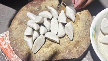 A person is cutting up some white dumplings video