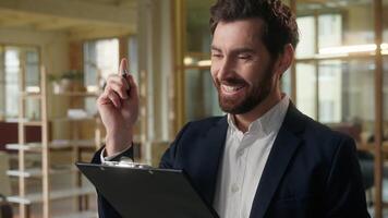 Businessman in office writing documents Caucasian business man sign contract insight create idea write papers agreement bank insurance successful deal happy employer agent corporate paperwork smiling photo