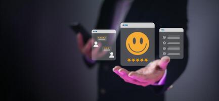 Businessman hand with glowing digital interfaces showing customer satisfaction, feedback, and task management, representing service quality, user experience, and business efficiency. photo