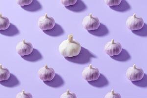 Garlic pattern on purple pastel background. photo