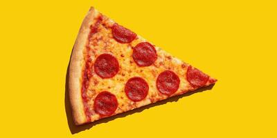 single slice of pizza on bright yellow background, strong shadows. photo