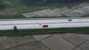 Isolated toll road surrounded by wet rice fields video