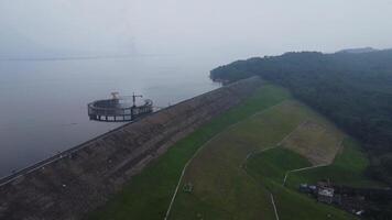 An aerial summer landscape view of the giant dam under a cloudy sky video