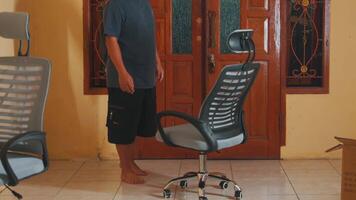 Person Adjusting an Office Chair in a Casual Room video