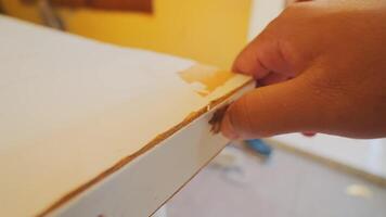 Close-Up of Hand Peeling Damaged Surface video