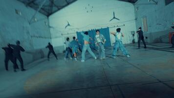 Group of people engaged in a tug of war inside an industrial building, depicting teamwork and competition. video