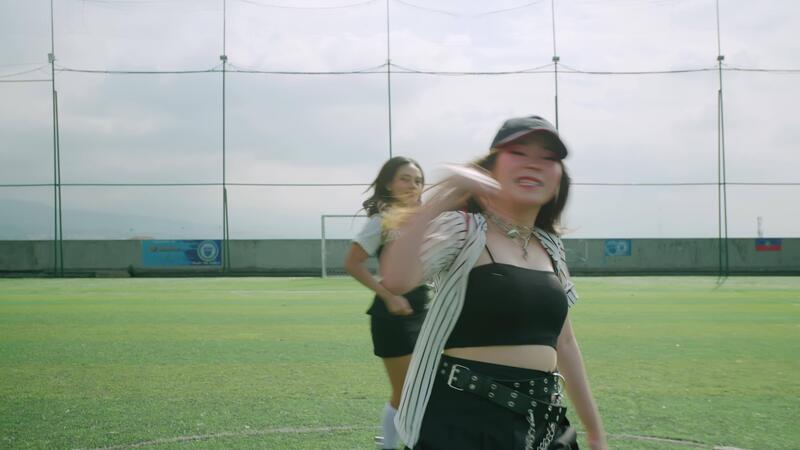 A vibrant dance scene on a sports - A Vibrant Dance Scene On A Sports Field Featuring Three Dancers In Stylish Outfits The Foreground Dancer Is In Motion Creating A Dynamic Atmosphere Video