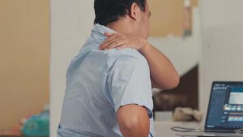 Man Experiencing Shoulder Pain While Working on Laptop video