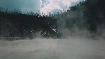Misty Landscape with Steaming Lake and Rocky Terrain video