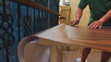 Person Sanding a Wooden Surface in a Vibrant Setting video