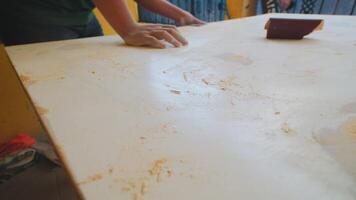 Sanding a Wooden Surface in a Workshop video