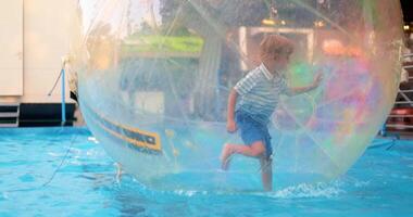 Child Enjoying Water Walking Ball Adventure in Pool video