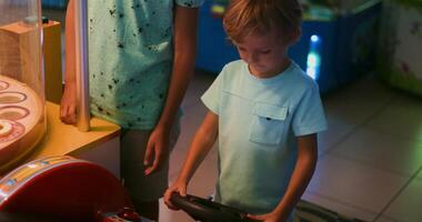 Child Enjoying Arcade Game in a Colorful Entertainment Center video