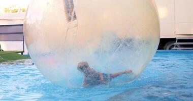 Child Playing Inside Inflatable Water Ball in Pool video