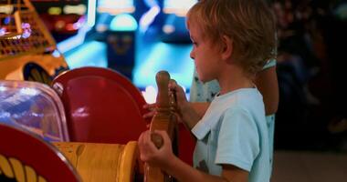 Child Enjoying Arcade Game at Entertainment Center video