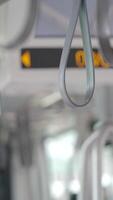 Hand holding bus strap in urban public transport setting video