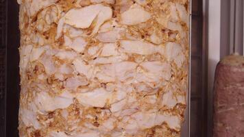 close-up of rotating chicken doner kebab meat on a vertical spit video