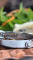 Honey drips from a spoon in bright kitchen setting video