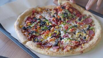 Delicious pizza loaded with fresh toppings at local eatery video