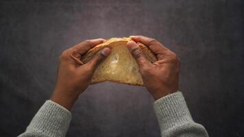 Soft bread is pulled apart with hands in close-up video