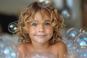 Smiling Caucasian boy with curly hair surrounded by bubbles, capturing a moment of joy and innocence. photo