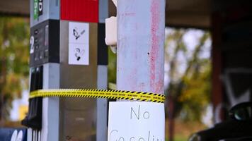 Empty Gas Station Pump with No Gasoline Sign and Warning Tape in Suburban Setting video