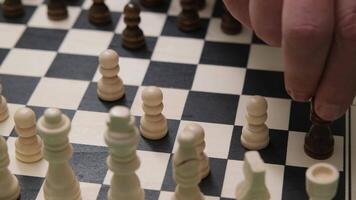 Intense Chess Match Strategy Captured as Player Moves Black Pawn on Classic Wooden Chessboard in Cozy Indoor Setting video