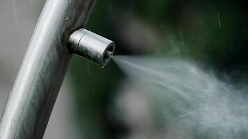 Close-up of Metal Nozzle Spraying Fine Water Mist for Humidification and Cooling Outdoors video