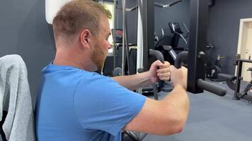 Caucasian man in a gym setting, engaged in a focused workout fitness routine strength training indoor exercise environment video