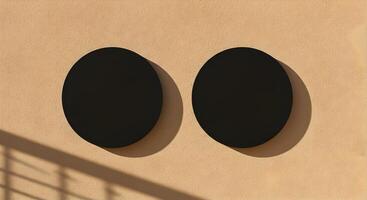 Double black circular billboards on stucco wall with dramatic afternoon shadows. photo