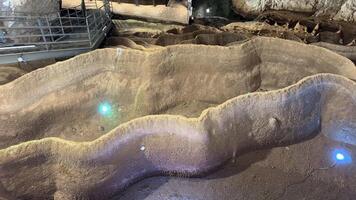 A captivating view of an underground cave with stalagmites, showcasing geological formations, spelunking adventures, and natural wonders video