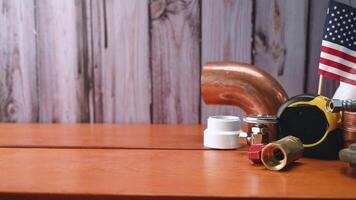 American flag with different copper water pipe and fittings plumber tools. video