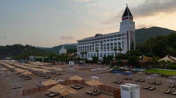 Turkey, Antalya 09.27.2024 Beachfront hotel with palm trees and forested hills video