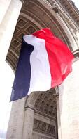 French flag under Arc de Triomphe in Paris, France 06.08.2025 video