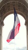 Backlit French flag under Arc de Triomphe in Paris, France 06.08.2025 video