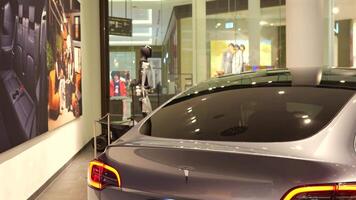 Rear view of Tesla car with robot and banners Berlin Germany May 28 2025 video