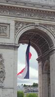 Vertical closeup of French flag under Arc Triomphe in Paris, France 06.08.2025 video