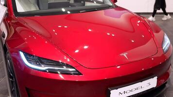 Front view of red Tesla Model 3 with headlights Berlin Germany May 28 2025 video