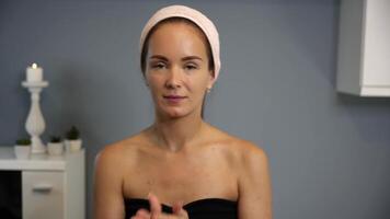 Applying facial serum with tapping motion at home video