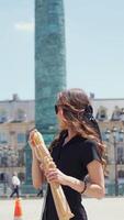 Woman holding baguette at Place Vendome in Paris video